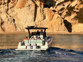 A group enjoys a scenic boat ride along a stunning coastline, perfect for exploring beautiful destinations and creating unforgettable memories.
