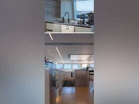 A sleek and modern kitchen interior aboard a luxury yacht, featuring high-end appliances and ample natural light, perfect for entertaining guests while at sea.