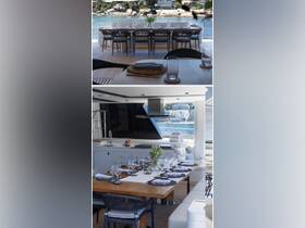 Elegant dining area inside a luxury yacht, featuring a beautifully set table with glassware and a scenic view of the water, perfect for upscale dining experiences on the water.