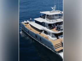 A stunning aerial view of a luxury yacht cruising through calm waters, showcasing its sleek design and spacious deck, perfect for upscale boating experiences.