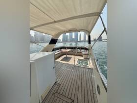 Interior view of a boat's helm area featuring comfortable seating and a spacious layout, perfect for relaxing while enjoying the water.
