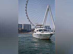 A sleek yacht navigates the waters near a prominent Ferris wheel, showcasing a perfect blend of luxury and leisure in a vibrant urban setting.