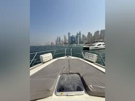 A stunning view from the front deck of a yacht, showcasing the vibrant city skyline as the boat navigates through the water.