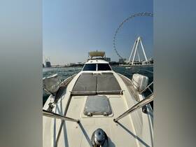 A stunning view of the front deck of a yacht, showcasing its sleek design against a backdrop of a prominent Ferris wheel, perfect for luxury cruising experiences.