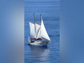 A beautiful sailboat glides through calm waters, showcasing its elegant sails and inviting atmosphere for sailing adventures.