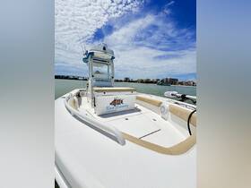 A stunning view of the 'Knot Stressing' center console boat, showcasing its sleek design against a vibrant sky and waterfront backdrop — perfect for fishing charters and day trips.