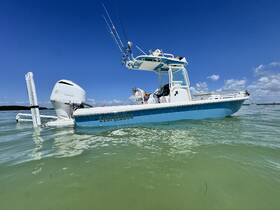 A sleek Everglades boat is showcased against a vibrant blue sky, perfect for fishing or leisurely outings on the water.
