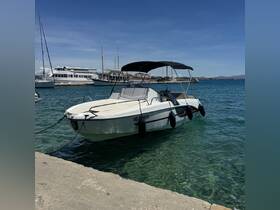 A sleek speedboat docked at a marina, showcasing its clean lines and inviting design against a backdrop of clear blue waters.