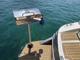 A close-up view of a mounted grill on a boat, showcasing the onboard amenities designed for cooking and entertaining while enjoying time on the water.