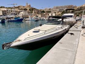 A sleek speedboat docked in a picturesque marina, surrounded by charming buildings and vibrant boats, perfect for exploring coastal destinations.