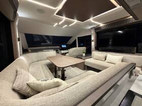 A stylish and spacious interior of a boat featuring comfortable seating and modern amenities, perfect for relaxing during a cruise.