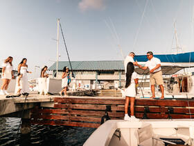 A joyful family gathers at the dock, preparing for a boat trip, showcasing a moment of celebration and togetherness before embarking on their adventure.