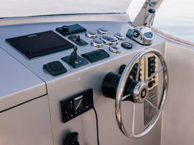 A close-up view of a boat's helm and console, showcasing the modern navigation equipment and controls essential for steering and operating the vessel.