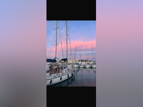 A picturesque view of sailboats docked at sunset, showcasing the serene beauty of a marina under a colorful sky.