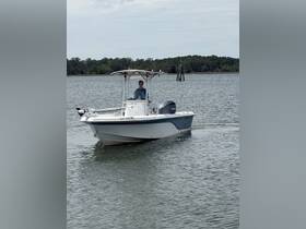A person navigates a speedboat through calm waters, showcasing the thrill of boating adventures.