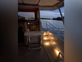 A cozy view of the helm area inside a boat, showcasing the steering console and ambient lighting, perfect for evening cruises.