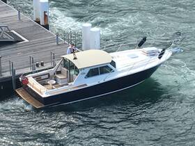 A sleek speedboat is seen approaching the dock, showcasing its elegant design and spacious deck, perfect for a day on the water.