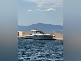 A sleek yacht docked at a marina with a scenic mountain backdrop, perfect for exploring coastal destinations.
