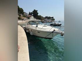 A sleek speedboat docked in clear turquoise waters, showcasing its elegant design against a picturesque coastal backdrop.