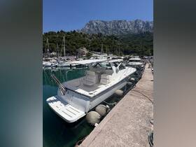 A sleek speedboat docked in a serene marina, surrounded by lush greenery and mountains — perfect for a day on the water.