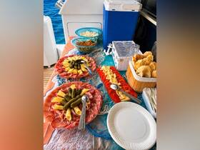 A beautifully arranged spread of charcuterie and snacks on a boat, perfect for enjoying while cruising the open waters.