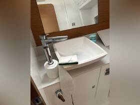 A clean and modern boat bathroom featuring a stylish sink and essential amenities, perfect for comfort while at sea.