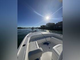 A view of the interior seating area of a boat, showcasing the helm and spacious layout, perfect for a day on the water.