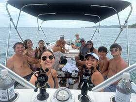 A lively group enjoys a fun day on the water, capturing smiles and camaraderie aboard their boat. Perfect for celebrating special moments with friends and family.