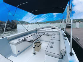 Interior view of a spacious boat cabin featuring comfortable seating and a sleek helm, perfect for relaxing while enjoying a day on the water.