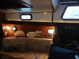 A cozy interior view of a boat cabin featuring comfortable seating and nautical decor, perfect for relaxing during voyages.