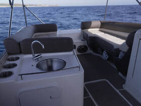 Interior view of a boat's seating area and console, showcasing a sleek design perfect for relaxation and enjoyment on the water.