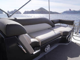 A stylish seating area inside a boat, featuring comfortable cushions and a sleek design, perfect for relaxing while enjoying the scenic views.