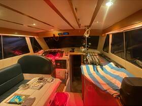 Interior view of a boat's helm and cabin area, showcasing the console and seating arrangements, ideal for navigation and relaxation.