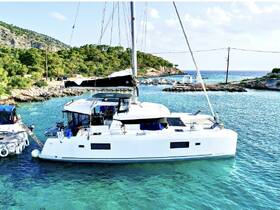 A stunning catamaran docked in crystal-clear waters, surrounded by lush greenery and rocky shores, perfect for exploring coastal destinations.