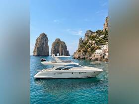A stunning yacht anchored in the clear waters near the iconic Faraglioni rocks of Capri, showcasing the beauty of luxury boating in a picturesque setting.