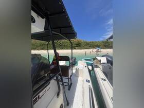 A view from a boat showing a beach scene with people enjoying the water, perfect for family outings and beach adventures.