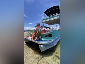 Two children and a dog enjoy a sunny day on the boat at the beach, creating cherished family memories in a fun and playful atmosphere.