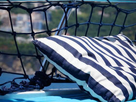 A close-up view of a striped cushion on a boat, perfect for lounging and enjoying the sun while cruising on the water.