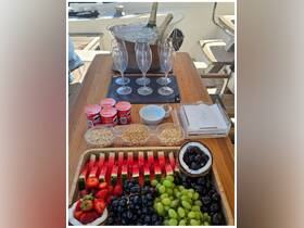 A beautifully arranged spread of snacks and drinks on a boat, featuring fresh fruit, champagne, and Pringles — perfect for a relaxing day on the water.