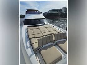 A cozy lounge area on a yacht, featuring plush seating perfect for relaxation while enjoying scenic views. Ideal for sunbathing or socializing on the water.