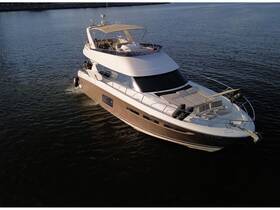 Aerial view of a luxurious yacht cruising through calm waters, showcasing its elegant design and spacious deck — perfect for upscale boating experiences.