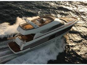 A stunning aerial view of a luxury yacht cruising through the waves, showcasing its sleek design and elegance on the water.