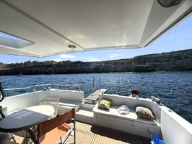 A serene view from the deck of a boat, showcasing a child enjoying the water with stunning cliffs in the background — perfect for family outings and relaxation on the water.