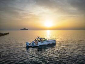 A stunning sunset view of a boat cruising on calm waters, with guests enjoying the serene atmosphere — perfect for evening excursions and romantic getaways.