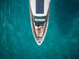 An aerial view of a couple relaxing on the deck of a yacht, surrounded by stunning turquoise waters — a perfect scene for a romantic getaway.