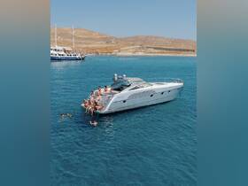 A lively group enjoys a sunny day aboard a yacht, with some swimming in the clear turquoise waters — perfect for summer parties and beach outings.