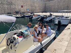 A cheerful group enjoys their time on a boat at the harbor, perfect for a day of exploration and fun on the water.