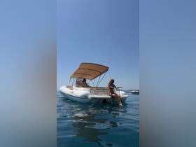A woman enjoys a relaxing moment on a boat, soaking up the sun and the serene waters — perfect for summer adventures and leisure outings.