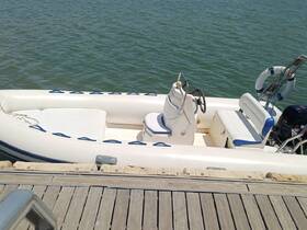 Interior view of a well-equipped boat featuring comfortable seating and a helm, ideal for leisurely outings on the water.