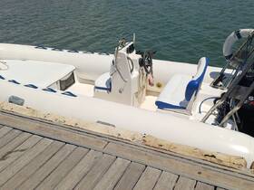 Interior view of a well-equipped boat helm featuring comfortable seating and a console, ideal for navigating the waters.
